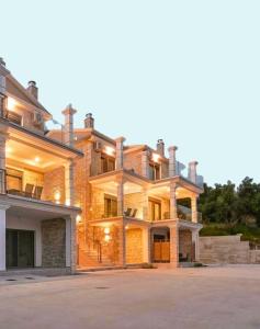 a large brick house with a large driveway at Milion Living Residences in Parga