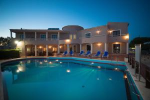 a villa with a swimming pool at night at Casa Rosa Montes in Luz
