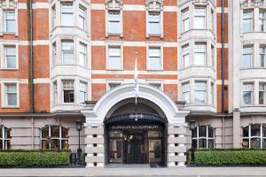 a building with a flag in front of it at Radisson Blu Hotel, London Bloomsbury in London