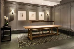 a table in a room with pictures on the wall at Radisson Blu Hotel, London Bloomsbury in London