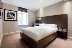 a bedroom with a large bed and a window at Radisson Blu Hotel, London Bloomsbury in London