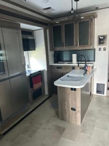 a kitchen with a sink and a counter top at Raleigh RV Living- Sleeps 8 