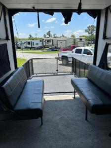 a porch with couches and a view of a parking lot at Raleigh RV Living- Sleeps 8 