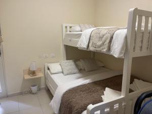 a bedroom with two bunk beds in a room at Brand New Apartament Durres in Durrës