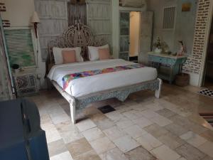 a bedroom with a large bed in a room at HI Lonny Villa Seminyak in Seminyak +20 photos