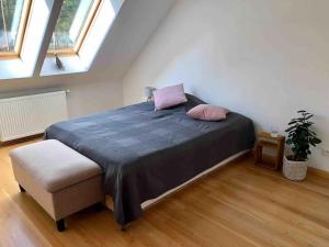 a bedroom with a bed and a chair and windows at Relax in Tlen in Tleń