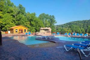 a swimming pool with lounge chairs and a house at Rhythm & Blues By Avada Properties in Gatlinburg