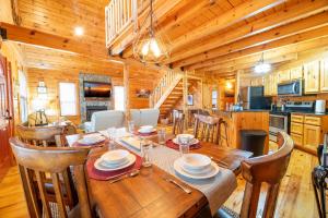 a dining room with a table and chairs in a cabin at Rhythm & Blues By Avada Properties in Gatlinburg