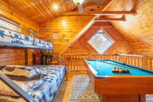 a bedroom with a pool table in a cabin at Rhythm & Blues By Avada Properties in Gatlinburg