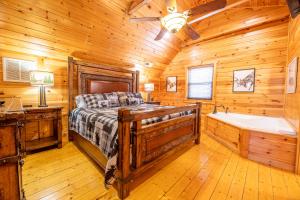 a bedroom with a bed and a tub in a room at Rhythm & Blues By Avada Properties in Gatlinburg +24 photos