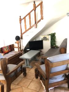 a living room with wooden furniture and a staircase at Villa provençale La Banisté in Saint-Cézaire-sur-Siagne