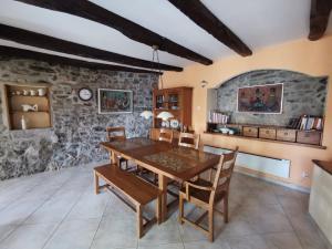 a dining room with a wooden table and chairs at Domus Carstica in Sežana +16 photos