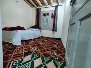 a room with a room with two beds and a floor at K6 Hotel & Camping Kande in Kande