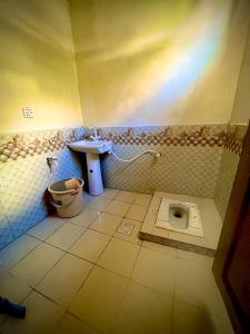 a bathroom with a sink and a toilet in a room at K6 Hotel & Camping Kande in Kande