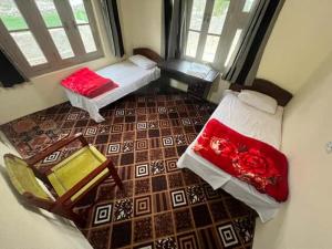 an aerial view of a room with two beds at K6 Hotel & Camping Kande in Kande