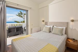 a bedroom with a bed with a view of the ocean at Villa Piedra Acharavi in Acharavi +28 photos