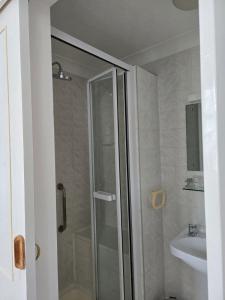 a bathroom with a shower and a sink at Shoreline Accommodation in Bournemouth