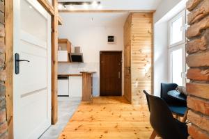 a room with a brick wall and a door at Premium Basement Apartament by Vibe Hostel in Sopot