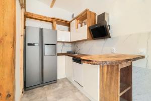 a kitchen with a refrigerator and a counter at Premium Basement Apartament by Vibe Hostel in Sopot