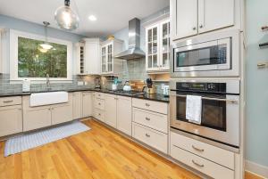 a kitchen with white cabinets and stainless steel appliances at 1104 Demere Road in Saint Simons Island