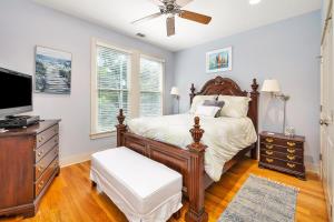 a bedroom with a bed and a flat screen tv at 1104 Demere Road in Saint Simons Island