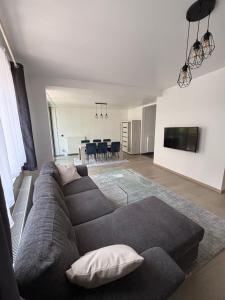 a living room with a couch and a dining room at Stylish, modern & spacious apartment in Brussels in Brussels