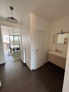 a room with a kitchen and a dining room at Stylish, modern & spacious apartment in Brussels in Brussels +30 photos