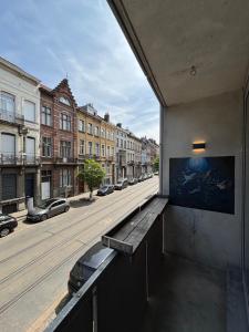 a view of a street from the balcony of a building at Stylish, modern & spacious apartment in Brussels in Brussels