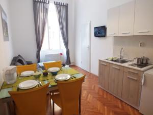 a kitchen and dining room with a table and chairs at Apartman Draguć in Pula