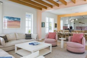 a living room with a couch and chairs and a table at New Waterfront Home - Dreamside House in Key West