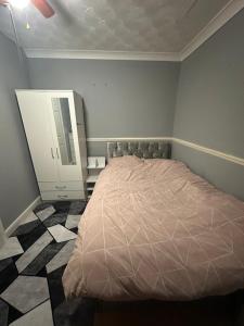 a bedroom with a bed and a dresser and a mirror at Double room in a shared house in Chatham
