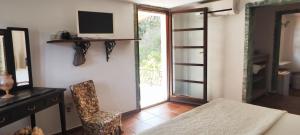 a room with a table and a chair and a window at Il giardino di FraFa in Quartu SantʼElena