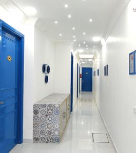 a hallway with a blue door and a hallway with a hallway sidx sidx at The Host By Amaris in Amritsar