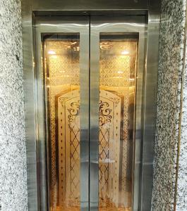a glass door of a building with gold windows at The Host By Amaris in Amritsar