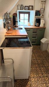 a kitchen with a stove and a sink in it at Urgemütlicher Winkelhof "La ferme von 1634" mit Terrasse in Simmerath +18 photos
