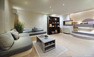 a living room with a couch and a bed at Ablaze Luxury Athens in Glyka Nera