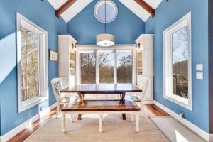 a dining room with a table and a blue wall at Sleeps 12 Hot Tub Private Dock Kayaks Dogs Welcome in Mill Spring