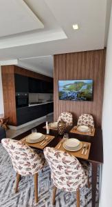 a dining room with a table and chairs at Bella Vista MEHDIA in Kenitra +16 photos
