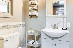 a white bathroom with a sink and a mirror at Less Than 1 Mi to Raystown Lake Family-Friendly Cottage! in Huntingdon +22 photos