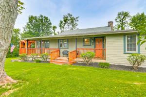 a house with an orange door and a yard at Less Than 1 Mi to Raystown Lake Family-Friendly Cottage! in Huntingdon