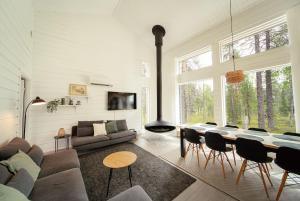 a living room with a couch and a table at 2-Wing Villa 4BR, 2 SkiPasses, Ylläs & Nature View in Ylläsjärvi