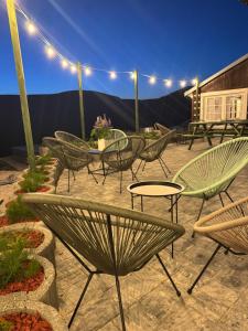 a group of chairs and tables on a patio at night at Bílá Labuť Pec in Pec pod Sněžkou
