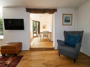 a living room with a chair and a television at 35 Main Street in Nottingham