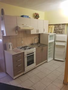 a small kitchen with a stove and a sink at Harley 1 Oder 6 in Karlobag