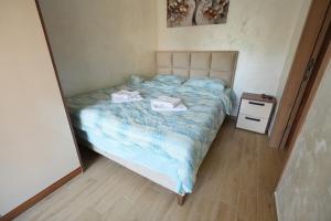 a bedroom with a bed with two towels on it at Green Hill Susic in Divčibare