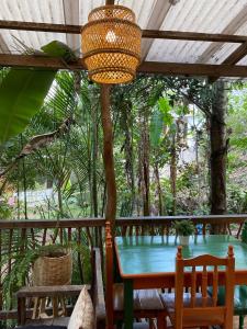 a table and chairs on a porch with a tree at Beautiful Cabin in Casa Papagayo, San Marcos, Atitlán in San Marcos La Laguna