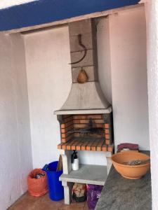 a kitchen with a brick oven in a room at Casa 13 in Montargil