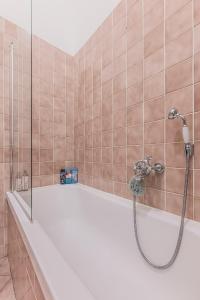 a shower in a tiled bathroom with a tub at Heart of Prague Lodgings 6 in Prague