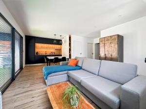 a living room with a couch and a table at Modern 2 bedroom house, sleeps up to 6 in Saint-Didier-de-Formans