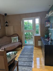 a living room with a couch and a table at Pichardts B&B & Lejligheder - La Maison Rouge in Tranekær